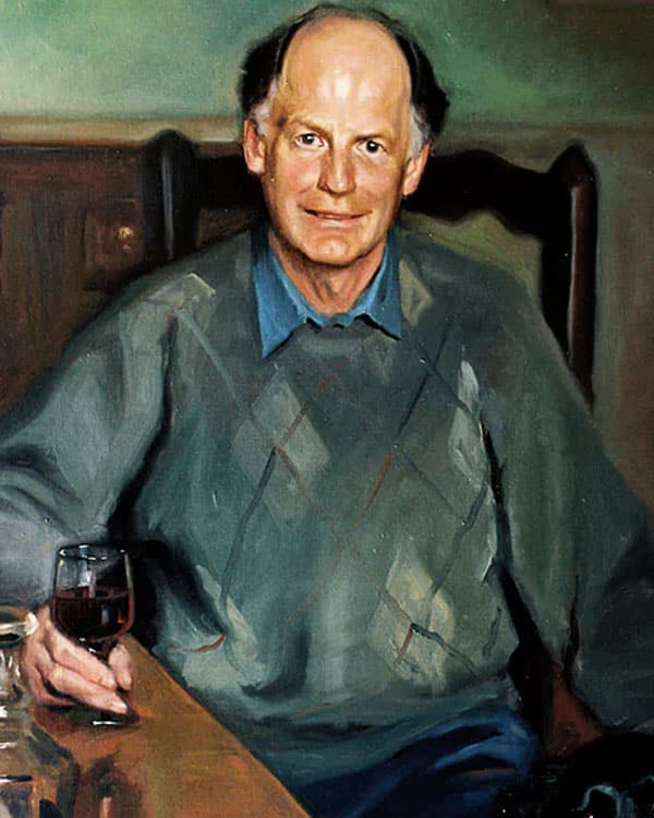 Oil portrait of a man in an argyle sweater with a glass of wine by Hazel Morgan